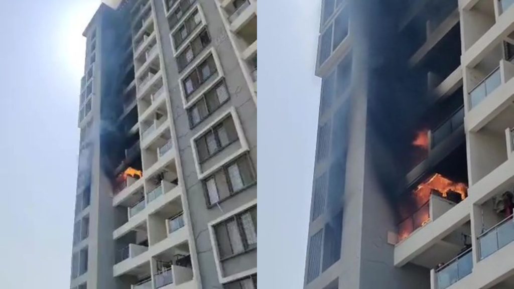 Flames and thick smoke emerging from the balcony of a high-rise apartment building at Menlo Society in Hinjawadi during the fire on Thursday afternoon.