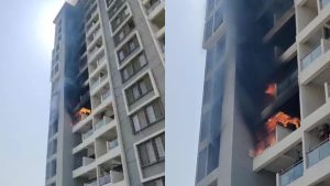 Flames and thick smoke emerging from the balcony of a high-rise apartment building at Menlo Society in Hinjawadi during the fire on Thursday afternoon.