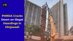 A tall yellow crane dismantling a large iron hoarding skeleton in front of high-rise residential buildings in Hinjewadi. The image includes a blue overlay on the left with yellow text reading "PMRDA Cracks Down on Illegal Hoardings in Hinjawadi" and a small gavel icon at the bottom.