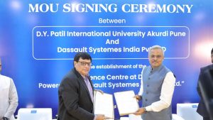 Two officials from D.Y. Patil International University and Dassault Systèmes India stand in front of a blue "MOU SIGNING CEREMONY" backdrop, holding signed folders and shaking hands to commemorate their partnership.