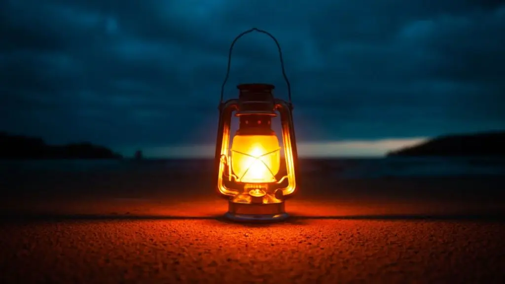 A wide-angle photo of an oil lantern, lit and placed in dark spot in the evening with hills and dark night in the background.