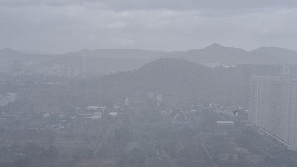 A wide angle photo of rain falling over the plains and distant hills of Hinjawadi Pune.