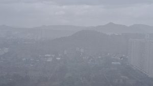A wide angle photo of rain falling over the plains and distant hills of Hinjawadi Pune.