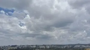 A wide-angle image of Pune sky showing the city skyline and scattered clouds in the sky right up to where eye can see, showing dry conditions in the city in the absence of monsoon rain.